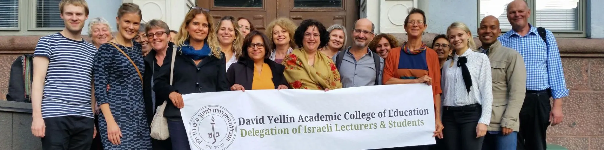 college_staff_holding_a_banner